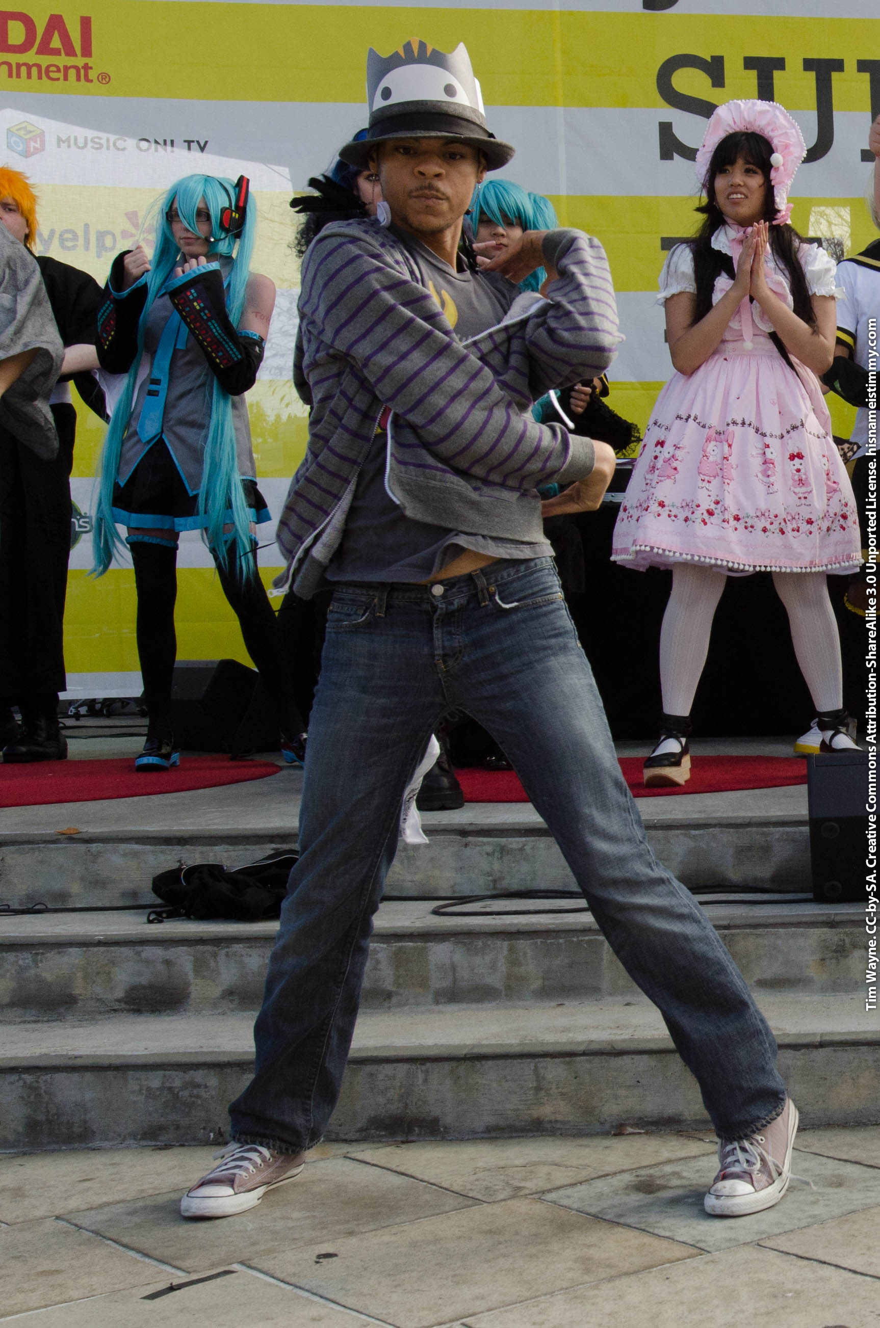 A voguing dancer in an extended floor pose.